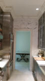 Painted and marbleized crown mould and door frame to match marble walls